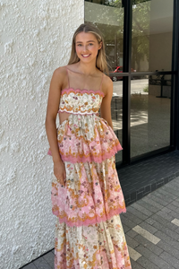 Get ready to turn heads in the Laurel Frill Maxi Dress! Perfect for weddings, baby showers, and garden events, this dress is both feminine and fun. You'll love the straight neckline with scallop cut detail, tiered frill skirt, and open back. Plus, the lace up corset allows for a comfortable fit on any body shape.