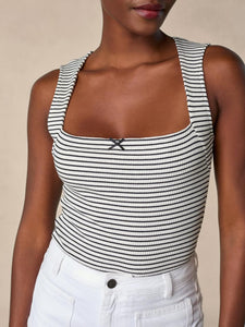 Enhance your wardrobe with the sophisticated Ilonka Top. This luxurious t-shirt features a unique trapeze neckline, adorned with a black satin bow for a touch of elegance. The black and white sailor print adds a touch of nautical charm, making this top a must-have for any fashion-forward individual. Plus, the mini ribbed jersey fabric ensures a comfortable and flattering fit. Elevate your style with Ilonka.