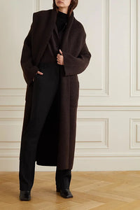 Indulge in luxury and sophistication with the Daelan Oversized Ribbed Wool Coat from The Row. Crafted in Italy from 100% wool, the dark brown longline design features bold shawl lapels and patch pockets, making it a must-have statement piece for the fashion-forward individual. Elevate your style and stand out from the crowd.