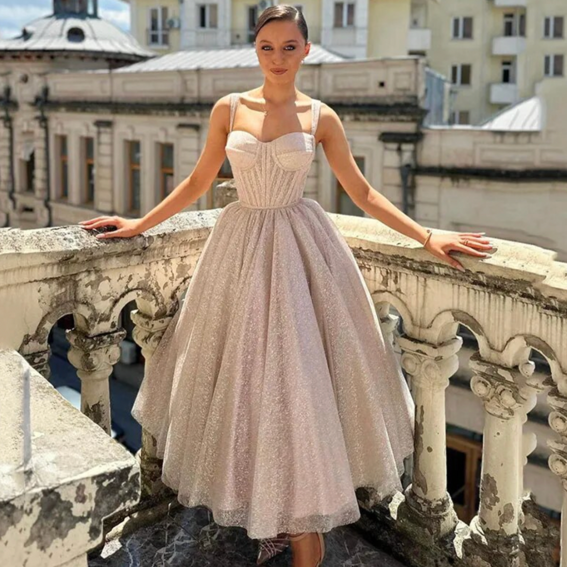 Expertly crafted with lustrous satin and delicate spaghetti straps, the Dress Loretta is the epitome of understated elegance. Its custom-made design features a chic V-neckline, alluring backless silhouette, and a sweeping train with a daring high slit. Make a statement on your special day with this simple yet stunning wedding dress.