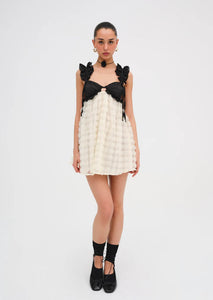 The Poppy Mini dress by For Love & Lemons is both pretty and practical, with 3D rose flock dot fabric, contrast satin cups, and supportive underwire. The chiffon ruffled straps and sheer skirt add a touch of elegance, while the keyhole at the back and invisible zip closure make it easy to wear. Fully lined for comfort.