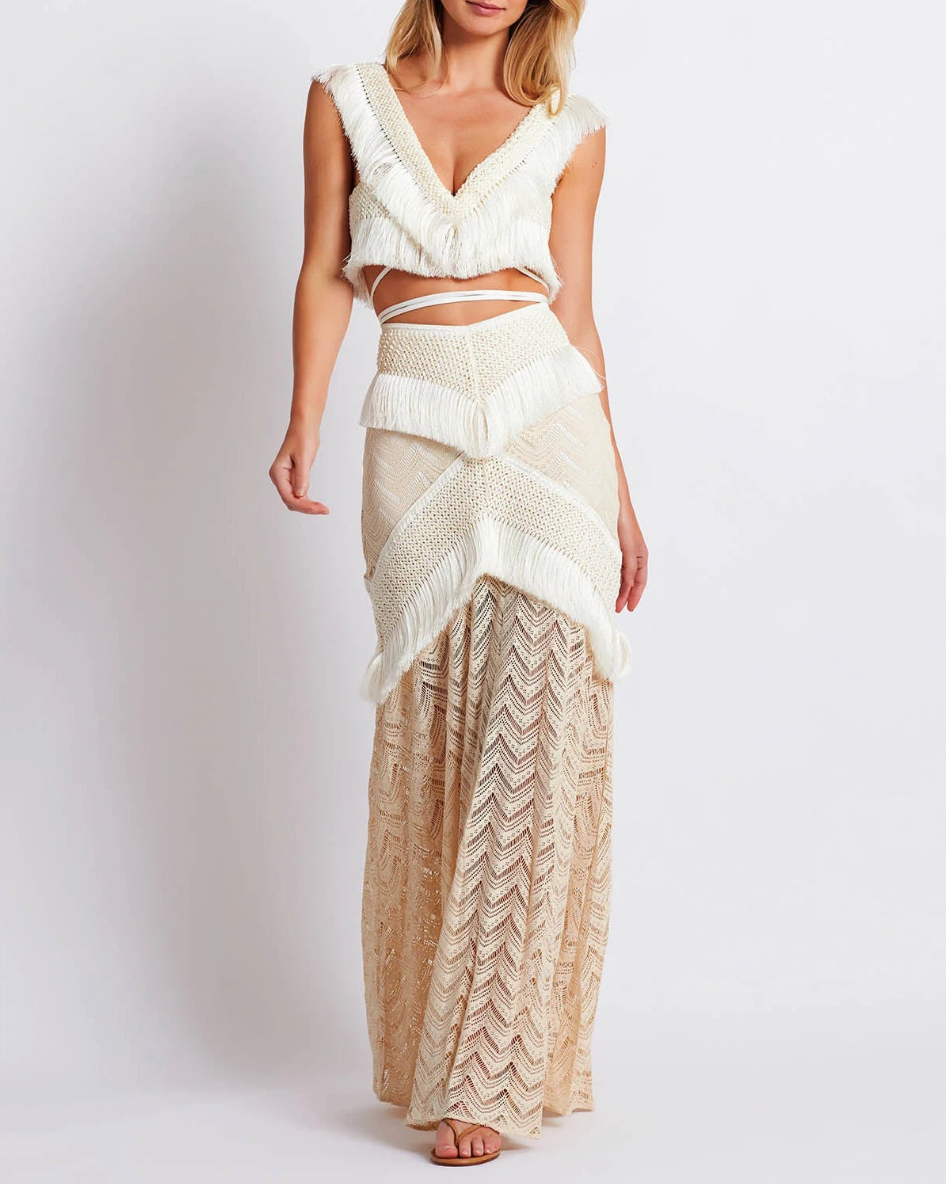 Experience elegance and boho-chic with our Fringe Trim Maxi Ensemble. Perfect for seaside parties and lively festivals, this ensemble is made from stretch modal lace and features a concealed back zip for a seamless finish. The playful fringe trims on the skirt add a touch of movement to elevate your look.