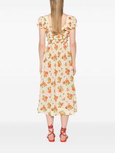 The Clarinet Floral-Print Midi Dress by Doen features a pale yellow floral print, a square neck, and short puff sleeves with elasticated cuffs. The smocked waist and bow detail at the front create a flattering silhouette. Perfect for adding a touch of spring to your wardrobe.