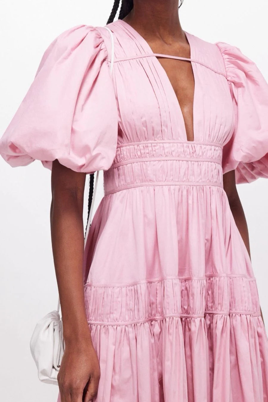 Elevate your special occasion look with the Fallingwater Ruched Midi Dress by AJE. Made from sweet 'Chalk Pink' cotton-poplin, this dress boasts a romantic and playful silhouette with voluminous puffed sleeves and a cinched waist. Rent now to make a stand-out statement!