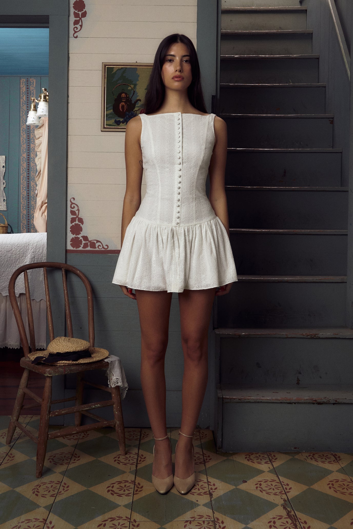 Discover the perfect combination of elegance and style with our Alette Dress. Featuring delicate white embroidery and lace, this dress is designed with a low waist and bodycon cut to highlight your figure. The open button neck adds a touch of sophistication to this sleeveless mini tank dress.