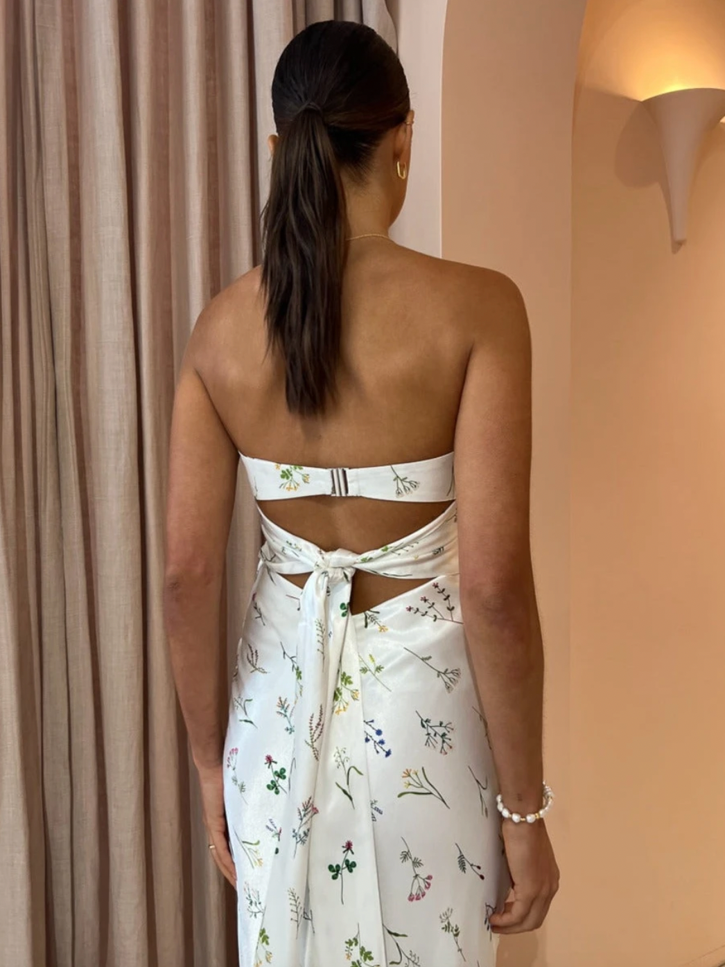 Carefully crafted from a premium viscose blend, this sophisticated midi features a strapless neckline and flattering bias cut that is accompanied by a luxe tie detail.  Designed to take you through the season with ease, it is perfect for wedding celebrations, summer soireès and garden parties.&nbsp;