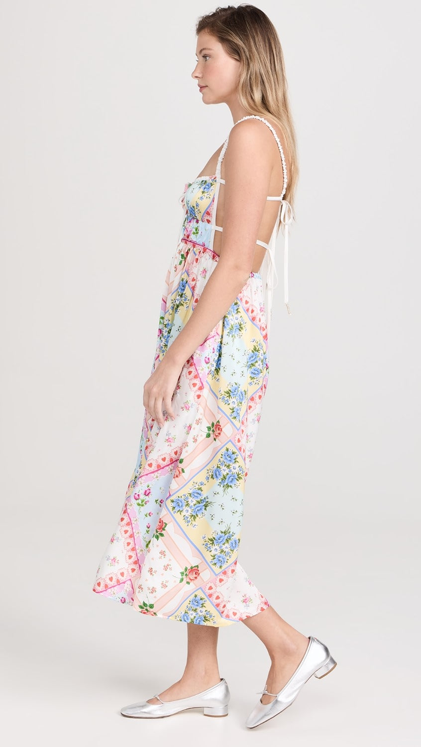 Get ready to turn heads in the Cassandra Floral Dress by For Love & Lemons! Made from lightweight, non-stretch satin, this dress features a stunning floral patchwork print and a crochet rose applique with a bow at the bust. The playful open back with ties and sweetheart neckline add a touch of fun to this dress. It also has ruched elastic shoulder straps, a covered elastic waistband, and convenient on-seam hip pockets.