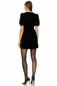 Indulge in luxury with the Cherie Mini Dress by Saloni. Short puff sleeves with button cuffs add a touch of elegance, while the round ruffle neckline exudes sophistication. The gathered waist and hidden zip provide a flattering fit, and on-seam hip pockets add practicality to this exclusive piece.