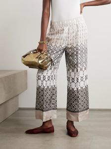 Expertly crafted by Brunello Cucinelli, these wide-leg pants are made from luxurious pure silk-voile for ultimate comfort. The elasticated waistband and neutral geometric pattern make them perfect for any vacation ensemble. Enjoy a stylish and comfortable look with these printed pants.