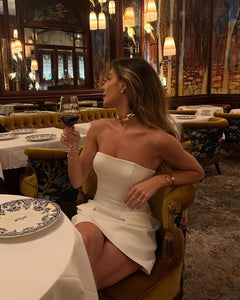 Indulge in luxury with the Estelle Mini Dress - a white, strapless masterpiece designed to accentuate your natural curves. Crafted with a stretch knit fabric, the fitted bodice creates a flattering silhouette while the faux pockets add a touch of elegance. This dress is a statement piece that will elevate your style for any occasion.