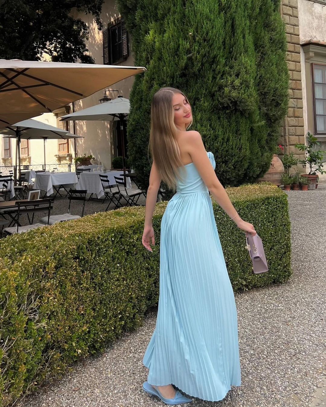 Indulge in the ethereal beauty of the 'Marcella' dress. Crafted from a luxurious ocean blue georgette, its shell-shaped pleats and boned bodice delicately define your décolletage while cinching your waist. The pleated maxi skirt moves gracefully with every step, making it perfect for high summer events and romantic dinner dates.