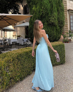 Indulge in the ethereal beauty of the 'Marcella' dress. Crafted from a luxurious ocean blue georgette, its shell-shaped pleats and boned bodice delicately define your décolletage while cinching your waist. The pleated maxi skirt moves gracefully with every step, making it perfect for high summer events and romantic dinner dates.