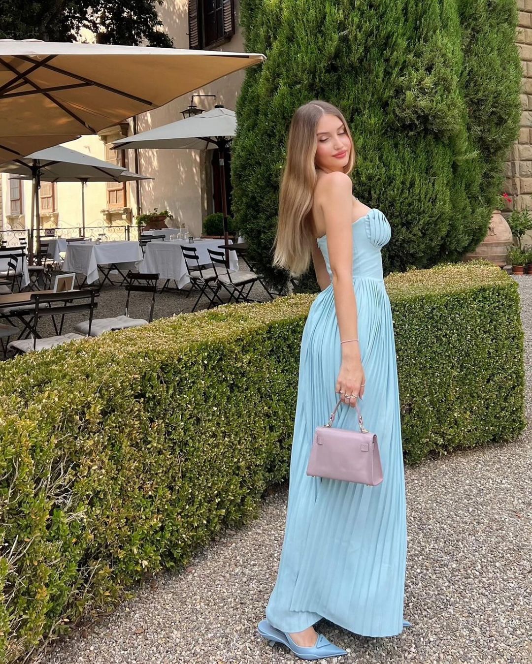 Indulge in the ethereal beauty of the 'Marcella' dress. Crafted from a luxurious ocean blue georgette, its shell-shaped pleats and boned bodice delicately define your décolletage while cinching your waist. The pleated maxi skirt moves gracefully with every step, making it perfect for high summer events and romantic dinner dates.