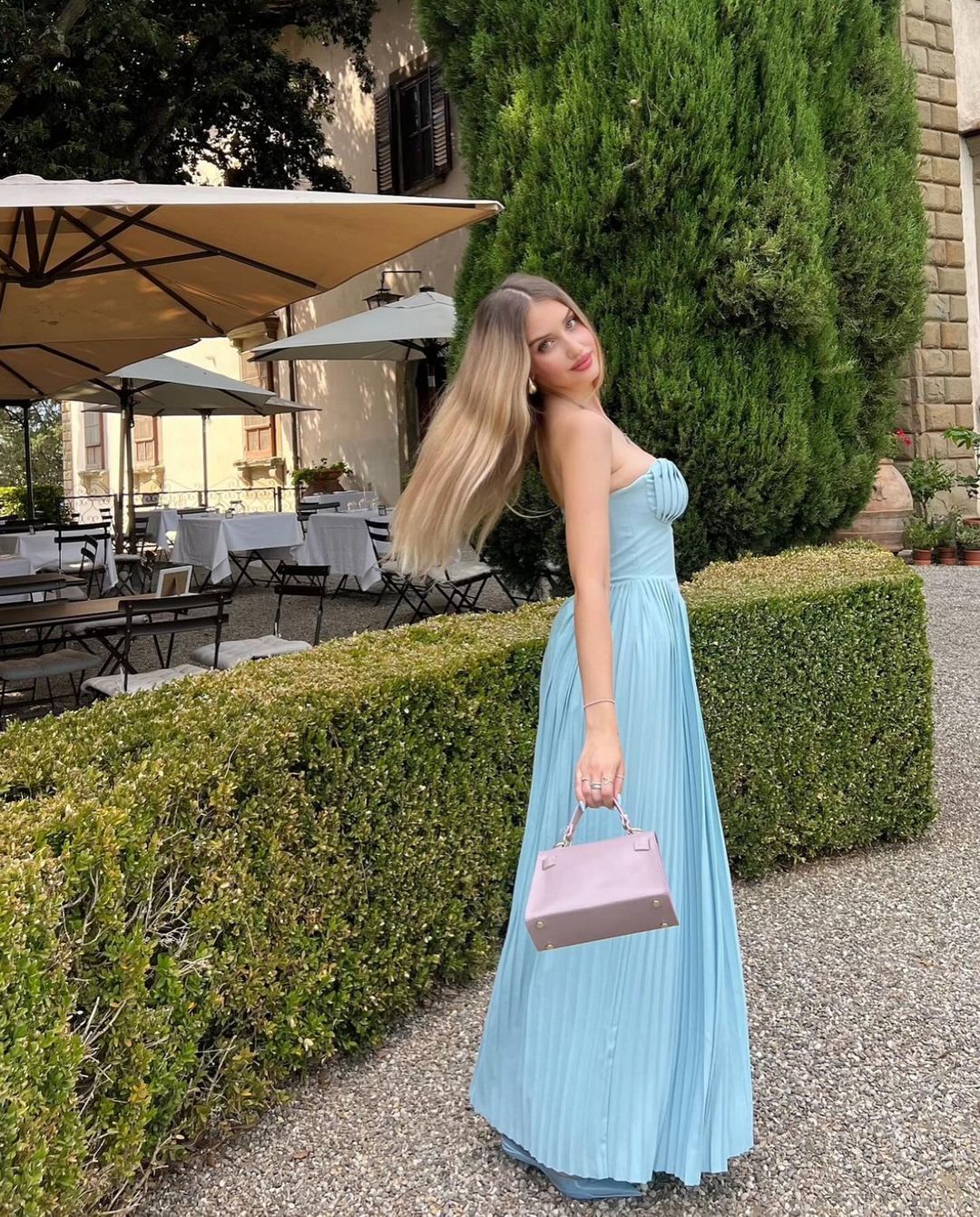 Indulge in the ethereal beauty of the 'Marcella' dress. Crafted from a luxurious ocean blue georgette, its shell-shaped pleats and boned bodice delicately define your décolletage while cinching your waist. The pleated maxi skirt moves gracefully with every step, making it perfect for high summer events and romantic dinner dates.