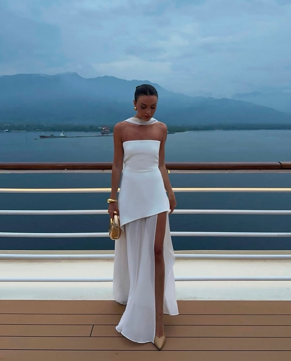 Indulge in luxury and make a statement with the Monaco Dress. The structured top and flowing chiffon layer create a stunning silhouette, while the sheer fabric and side slit add a touch of movement and dynamism. Perfect for upscale occasions and special moments, this elegant strapless dress will surely turn heads. Invest in a timeless piece to elevate your wardrobe.