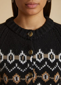 Elevate your wardrobe with the Suzette Cardigan by KHAITE. Crafted from a luxurious blend of cashmere, this black and multicolor cardigan features a Fair Isle intarsia pattern and a classic round neckline. The front button closure, long sleeves, and ribbed cuffs and hem add a touch of sophistication. Perfect for chilly days and nights.