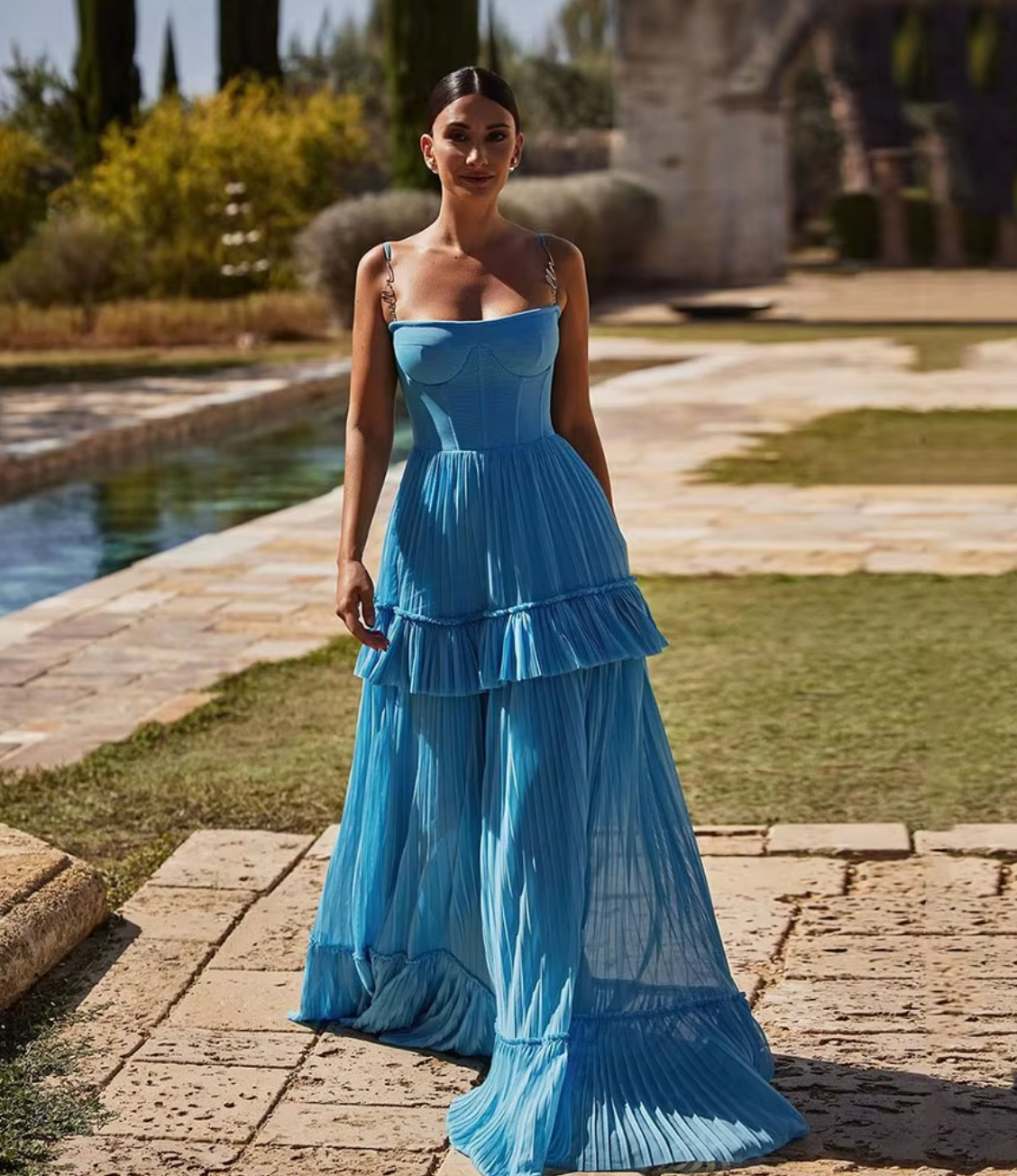  Indulge in elegance with the Eden Maxi Dress. The sky-blue mesh fabric creates a graceful silhouette with a structured boned bustier bodice, adorned with delicate spaghetti straps. The pleated A-line maxi skirt adds a touch of sophistication to your every step. Perfect for any special occasion.