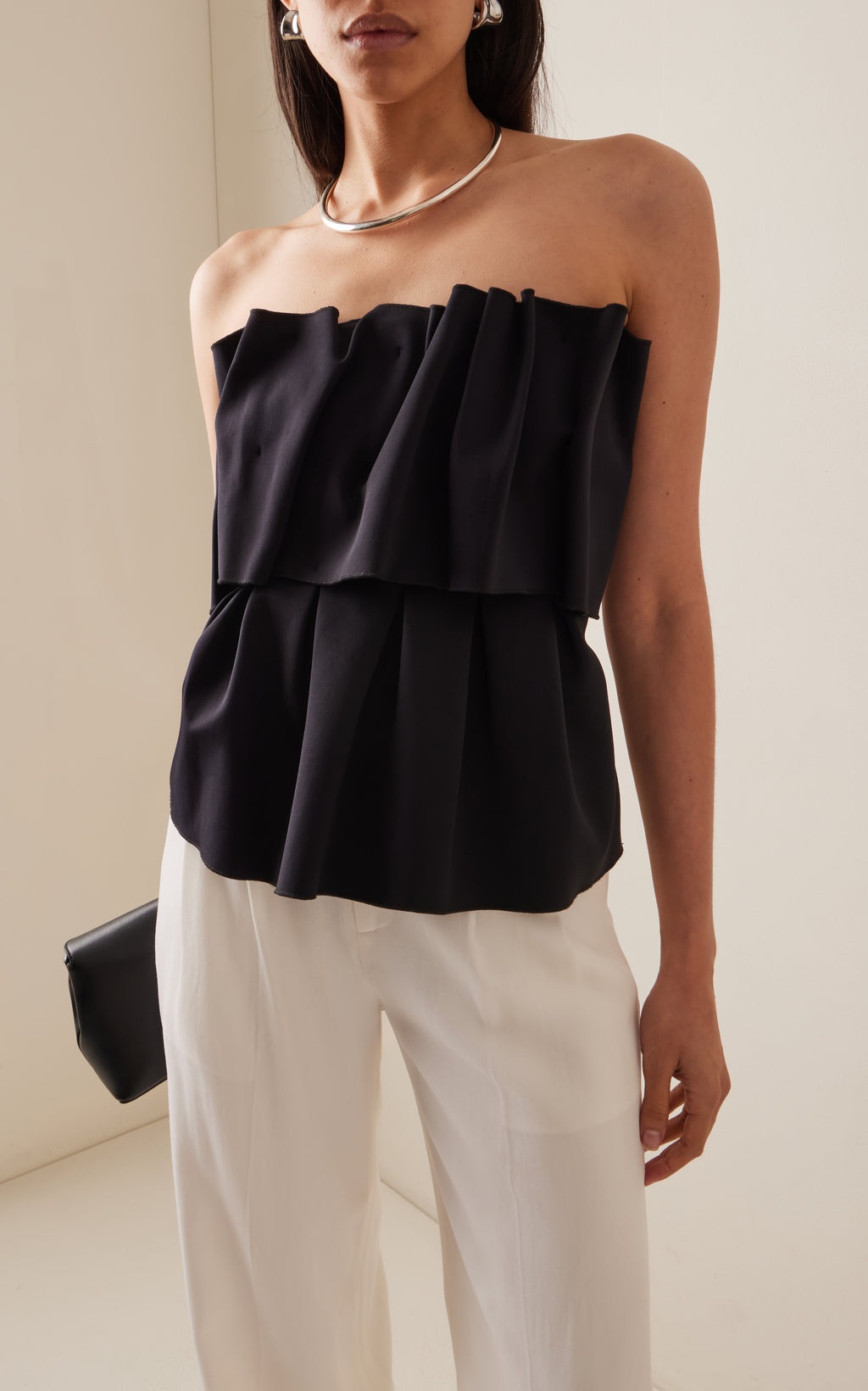 Expertly crafted from smooth stretch-crepe, the Sculpted Tube Top by House of Dagmar is a must-have for any fashion-forward individual. The strapless design boasts a gathered bust for a uniquely ruffled effect, adding a touch of effortless elegance to any outfit. Experience the perfect blend of style and comfort with this versatile top.