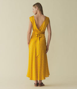 Indulge in luxury with the Tahlia Dress. Made from stunning silk-satin, this ‘30s-inspired dress exudes elegance with its plunging V-neckline, surplice back, and delicate ruffle trim. The adjustable back waist tie ensures a perfect fit, while the snap closure adds a touch of versatility. Perfect for any occasion.