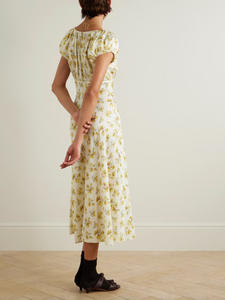 Indulge in luxury with the 'Florencia' midi dress. It exudes 1930s glamour with a vintage floral design and delicate gathering at the bodice. Made from a fluid silk-blend, this dress is cut on the bias for a flattering fit and has playful puffed cap sleeves. A sophisticated addition to your wardrobe.