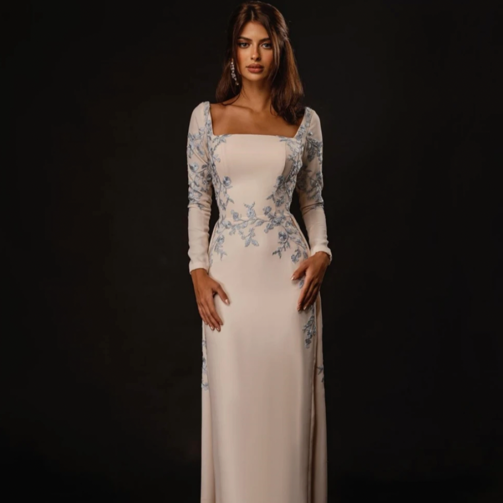 Elevate your style in our Dorothy gown. This square sheath evening dress boasts beautiful embroidery, cascading flowers, and luxurious satin. Perfect for formal events, this gown exudes elegance and sophistication. Get ready to turn heads and feel confident in this exquisite piece.