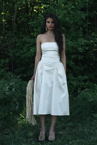 Introducing our Lily Dress, crafted with soft, breathable cotton for ultimate comfort. This strapless dress boasts a fitted bodice that accentuates your figure and transitions into a gathered hip, mid-length skirt. Its bold minimalist design highlights your natural curves, making it the perfect choice for dreamy summer days.