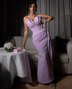 Experience elegance and vintage charm with our Dress Bethanie. This stunning evening gown features a sexy strapless design and eye-catching mermaid silhouette, adorned with sparkling sequins and playful ruffles. Perfect for special occasions, this dress will make you stand out with its unique and sophisticated style.