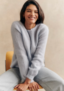 This cardigan is expertly crafted with kid mohair and merino wool for a soft and luxurious feel. The long balloon sleeves and open knit design add a touch of elegance, while the crochet finish along the button placket and neckline create a unique and sophisticated look. With a classic v-neckline and crochet buttons, this cardigan is both stylish and versatile.