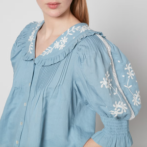 Introducing the Kyla Top from Sea New York - a blend of vintage and modern styles. Made from linen and cotton, this top boasts lace embellishment and floral embroidery, pairing beautifully with the Peter Pan collar for a romantic and airy look. Perfect with trousers and mules.