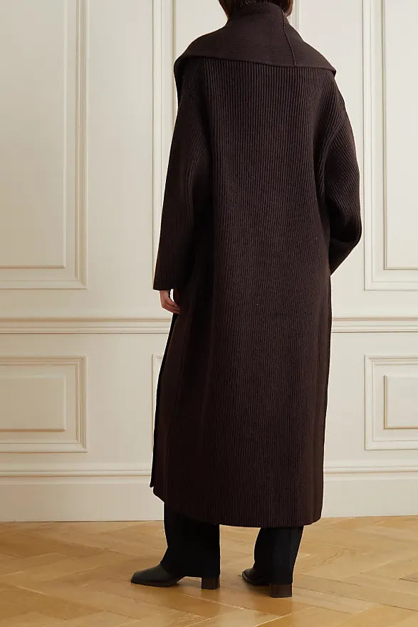 Indulge in luxury and sophistication with the Daelan Oversized Ribbed Wool Coat from The Row. Crafted in Italy from 100% wool, the dark brown longline design features bold shawl lapels and patch pockets, making it a must-have statement piece for the fashion-forward individual. Elevate your style and stand out from the crowd.