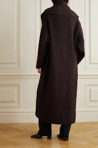 Indulge in luxury and sophistication with the Daelan Oversized Ribbed Wool Coat from The Row. Crafted in Italy from 100% wool, the dark brown longline design features bold shawl lapels and patch pockets, making it a must-have statement piece for the fashion-forward individual. Elevate your style and stand out from the crowd.