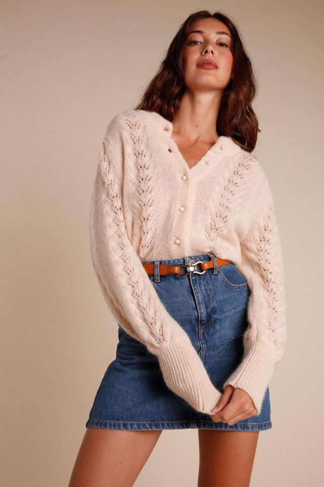 Indulge in the luxury of our Maddy cardigan. This intricately knitted piece features a delicate lace design, a round neckline, and long sleeves. The scalloped edges add a touch of elegance to the button details. Stay stylish and cozy with this must-have addition to your wardrobe.