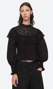 The Serita Top by Sea New York combines delicate crochet lace and intricate stitched pleats for a whimsical and feminine look. Add a touch of elegance and charm to any outfit with this beauty. (Elegant and whimsical, this top is a must-have for any wardrobe.)