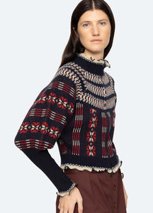 The Ayla Cardigan by SEA has a beautiful fair isle knit pattern and long puff sleeves, making it a stylish addition to any wardrobe. The exposed front zipper allows for easy on and off, while the ruffle detailing adds a touch of femininity. Made of 100% wool, this cardigan is designed for a comfortable and relaxed fit.