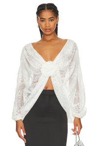 "Elevate your style with our Milk White Blouse Madeline. This sophisticated top boasts floral applique for a subtle, feminine touch and chic batwing sleeves. A must-have for any exclusive event or night out, this wrap lace top, handcrafted by Giussepe di morabito with %100 premium material, exudes luxury and class."