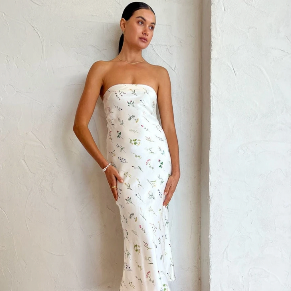 Carefully crafted from a premium viscose blend, this sophisticated midi features a strapless neckline and flattering bias cut that is accompanied by a luxe tie detail.  Designed to take you through the season with ease, it is perfect for wedding celebrations, summer soireès and garden parties.&nbsp;