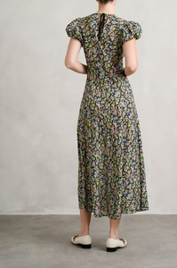 Indulge in effortless elegance with the DÔEN's ditsy floral dress. With delicate puffed sleeves and a flowy fit, this cotton silhouette falls just above the ankle for a chic and easy wear. Featuring a round neckline and tie detail at the back, it's perfect for any occasion - from chic ballet flats to stylish heels.