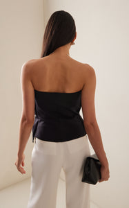 Expertly crafted from smooth stretch-crepe, the Sculpted Tube Top by House of Dagmar is a must-have for any fashion-forward individual. The strapless design boasts a gathered bust for a uniquely ruffled effect, adding a touch of effortless elegance to any outfit. Experience the perfect blend of style and comfort with this versatile top.