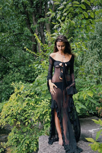 Unleash your inner enchantress with the Enchantress Dress! This stunning long sleeve maxi dress features 3 front ties that can be styled in a variety of ways, along with a high stretch fabric for optimal comfort. The double-lined chest and front thigh high slits add a touch of sultry to this feminine look, complete with ruffled hems on the slits and sleeves. Effortlessly captivate on any occasion with this dress!