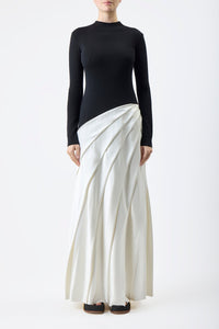 Indulge in luxury with the Ismay Silk Pleated Maxi Dress by Gabriela Hearst. This elegantly crafted piece boasts a clever design, featuring a black silk knitted bodice and a white pleated satin skirt for a striking contrast. The sharp pleats create beautiful movement as you walk, while the mock neckline adds a touch of sophistication. Perfectly paired with classic pumps for a timeless look.