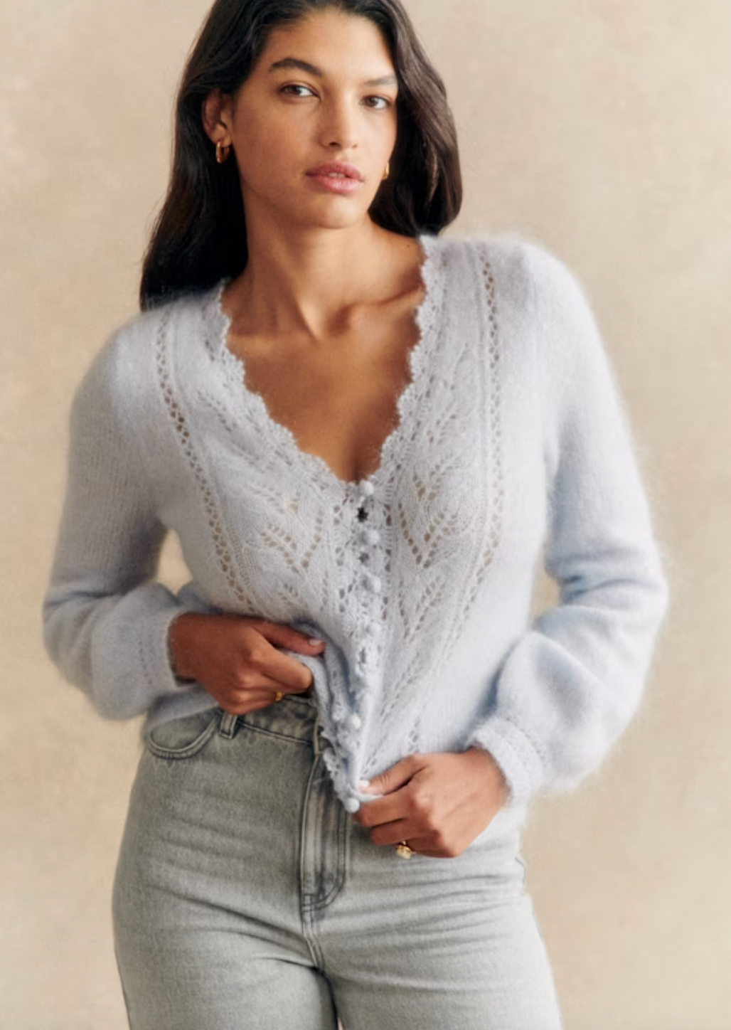 This cardigan is expertly crafted with kid mohair and merino wool for a soft and luxurious feel. The long balloon sleeves and open knit design add a touch of elegance, while the crochet finish along the button placket and neckline create a unique and sophisticated look. With a classic v-neckline and crochet buttons, this cardigan is both stylish and versatile.