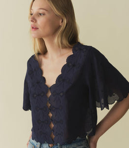 The Kacy Top by DOEN blends vintage charm with modern elegance. Crafted in 100% organic cotton voile, this blouse features charming cutouts, delicate bow embroidery, and breezy elbow-length sleeves. With scalloped details and delicate dot embroidery, this top is a playful yet sophisticated addition to your wardrobe.