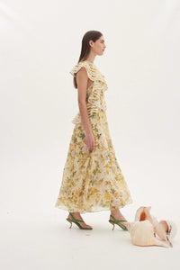 Introducing Dress Eden - the perfect blend of elegance and playfulness. Enjoy the summer breeze in this floral print long dress featuring an elegant O neck and playful sleeveless design. With charming ruffle details and flattering pleats, this dress is sure to turn heads. (Limited stock, grab yours now!)