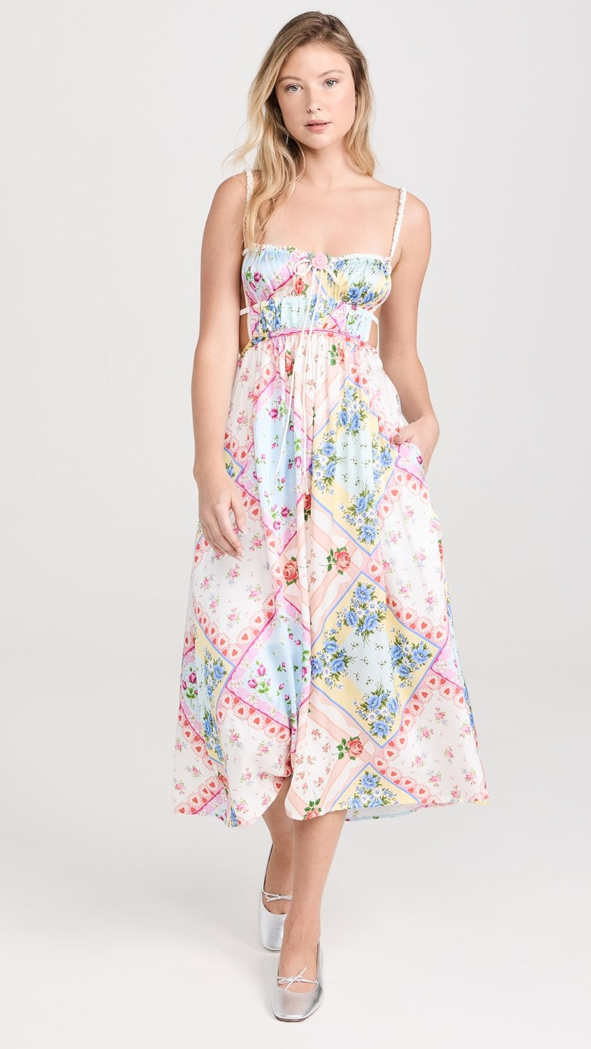 Get ready to turn heads in the Cassandra Floral Dress by For Love & Lemons! Made from lightweight, non-stretch satin, this dress features a stunning floral patchwork print and a crochet rose applique with a bow at the bust. The playful open back with ties and sweetheart neckline add a touch of fun to this dress. It also has ruched elastic shoulder straps, a covered elastic waistband, and convenient on-seam hip pockets.