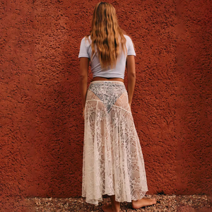 Elevate your style with the Lainey Lace Skirt. This stunning maxi skirt features a high waist for a flattering fit, and a see-through white lace design for a touch of allure. Perfect for a day at the beach or dressing up for a holiday, this skirt will add a playful and sexy vibe to your wardrobe.