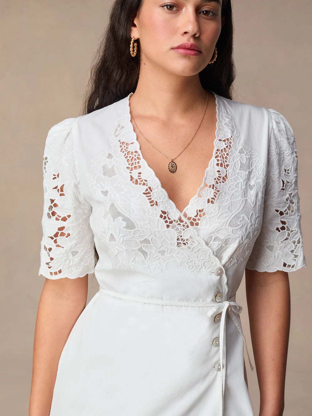 This stunning Audrey Midi Dress is perfect for any occasion. The elegant white embroidery adds a touch of sophistication, while the mid-length and wrap design create a flattering and versatile silhouette. Dress it up or down, this dress is sure to make you feel confident and chic!