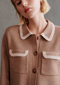 Expertly crafted from soft merino wool, the Betty Cardigan is perfect for cooler days. With a classic shirt collar and pockets on the chest, this short cardigan is finished with delicate crochet details on the collar, pockets, and cuffs. Elevate your wardrobe with this timeless and versatile piece.