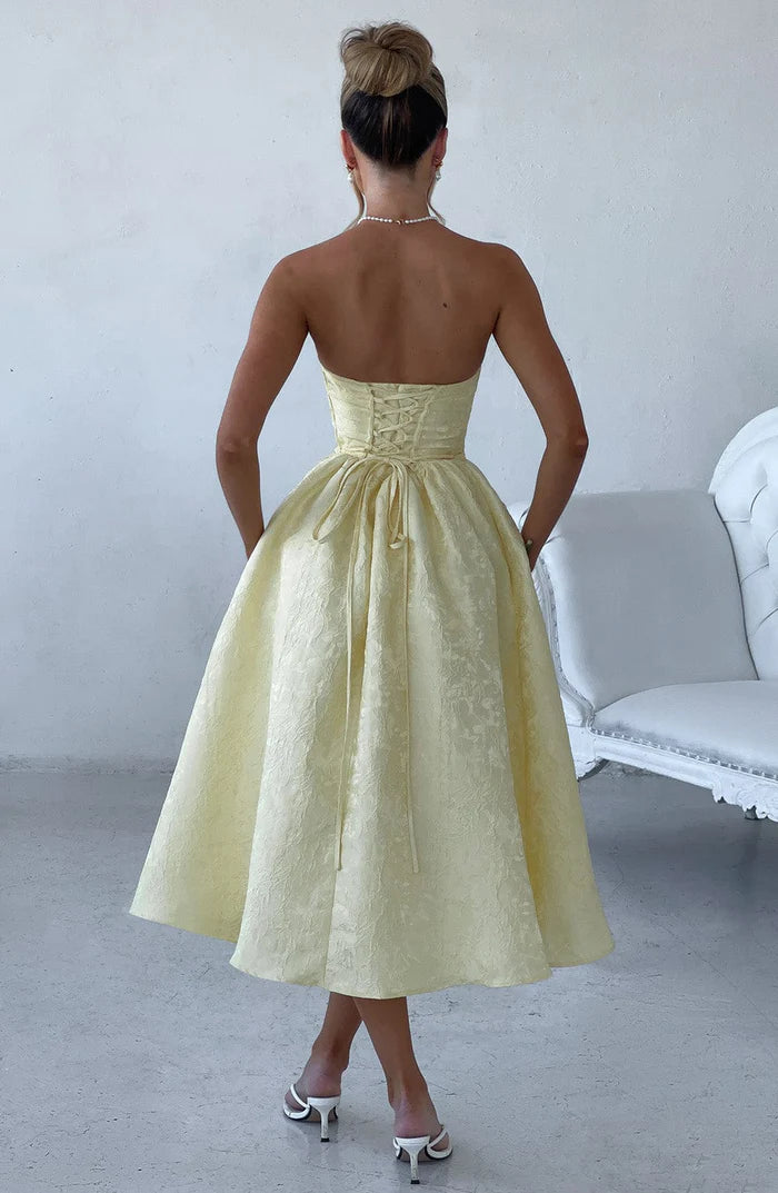 Experience year-round elegance with the Saoirse Dress. This playful strapless dress in Lemon features a boned bodice and full tulle-lined skirt, complete with gathered and pleated details. Perfect for any occasion, pair with heels and an updo for a chic look.