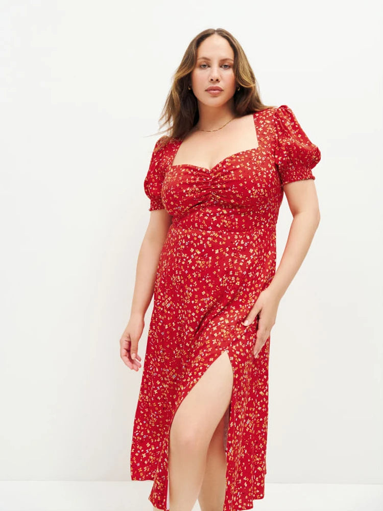 Indulge in the luxury and elegance of the Lacey Dress in Baila from Reformation. Its back smocking hugs your curves, while the sweetheart neckline adds a touch of femininity. The high slit and ruching details add a hint of sensuality to this lightweight, drapey crepe dress. A must-have for any sophisticated and exclusive wardrobe.