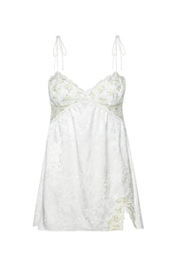 A spray of baby’s breath blooms lends a delicate romance to this pure white mini slip. Featuring embroidered tulle, luxe satin jacquard, ultra skinny tie straps, and a side slit for a look that’s not-so-innocent. FOR LOVE &amp; LEMONS FOR VICTORIA’S SECRET: An exclusive collaboration that blends dreamy confidence with thoughtful detailing, giving each piece a unique and feminine feel.